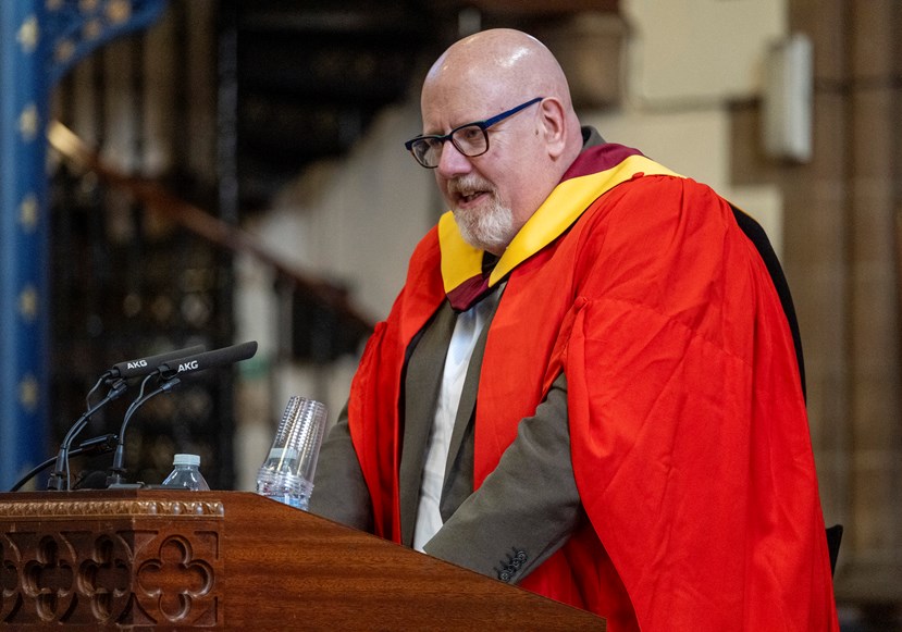Man speaking at a lectern