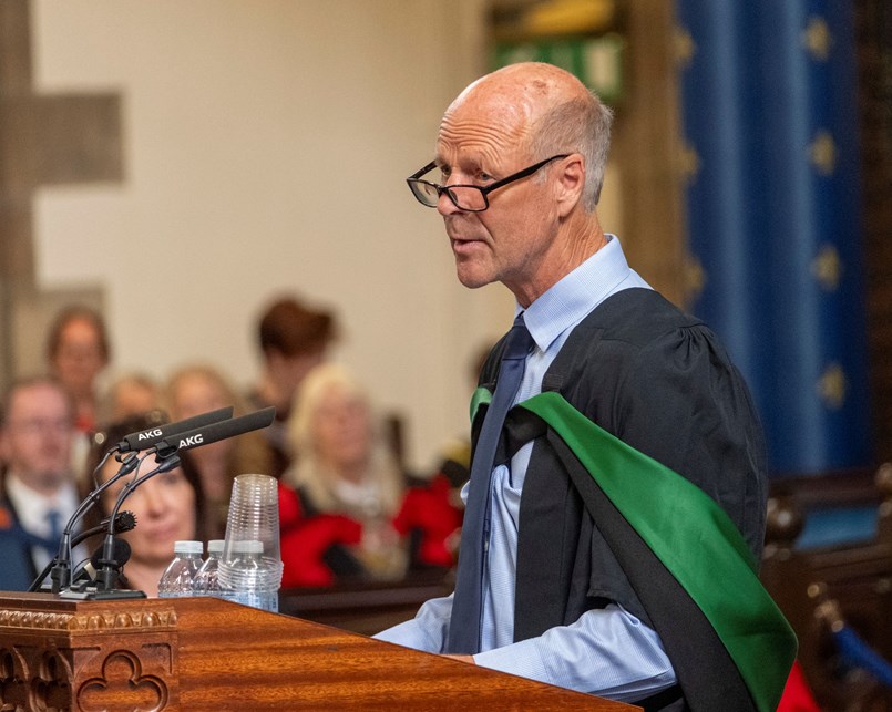 Man speaking at a lectern